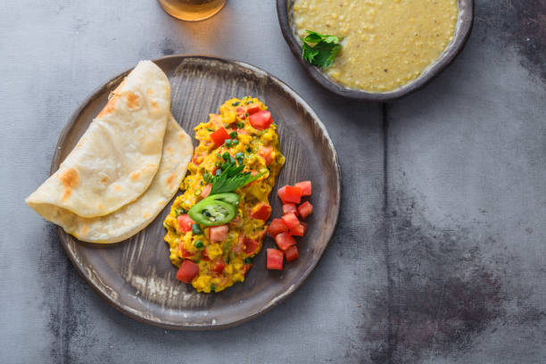 istock Indian Style scrambled eggs Akuri with paratha, dahl and ice tea, copy space 1180570289