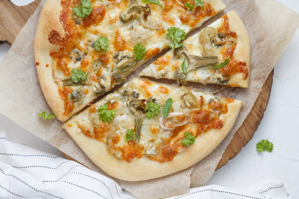 istock White cheese pizza with artichoke and arugula 1180571295