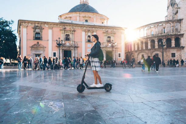 istock Woman riding scooter on her way to work 1180574093