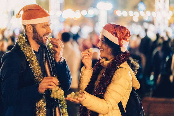 Christmas in Spain Happy couple celebrating New Year outside at night with grapes number 12 photos stock pictures, royalty-free photos & images