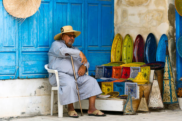 Africa, North Africa, Maghreb, South Tunisia, Governorat of Medenine. Djerba island. Houmt Souk. June 26, 2014. Ceramics merchant at the medina