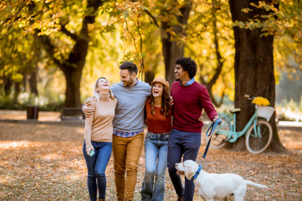 istock Multiracial young people walking in the autumn park and having fun 1180575761