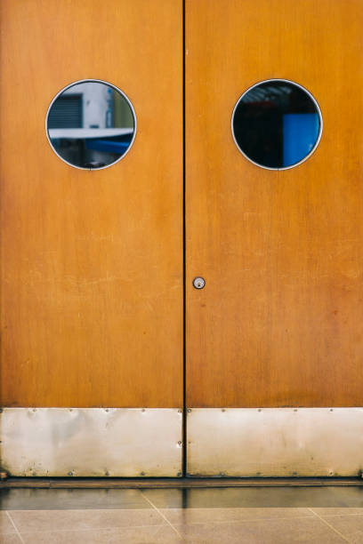 Closeup of the round windows at the orange door