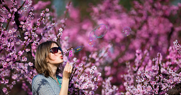 istock Beautiful  woman blowing soap bubbles 118057768