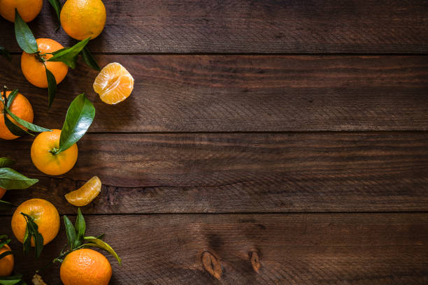 Fresh organic tangerines with copy space on rustic wooden table