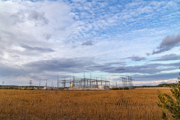istock Electrical sub station against the cloudy sky. Energy generation landscape. 1180578420