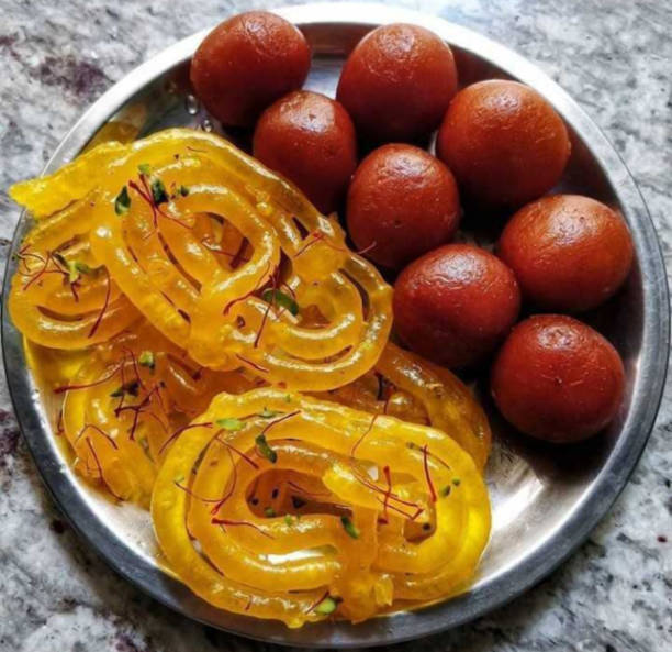 istock indian sweets jalebi and gulab jamun served in plate 1180580654