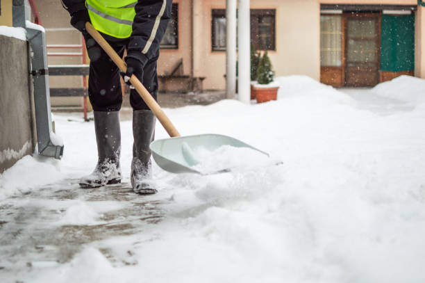 istock Man with snow shovel cleans sidewalk 1180583991