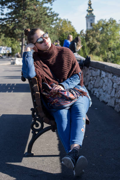 istock Beautiful Girl Sitting Alone 1180587034