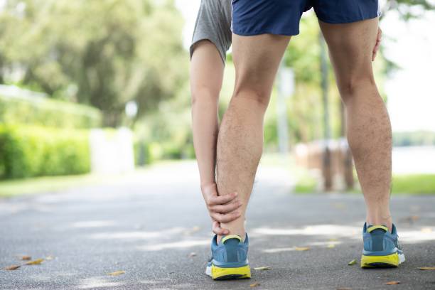 istock Picture of a man holding an ankle for exercise 1180589989