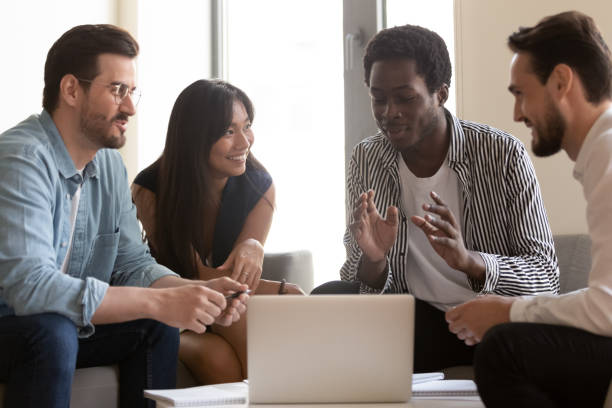 istock Multiethnic business team listen to african mentor explain online strategy 1180590176