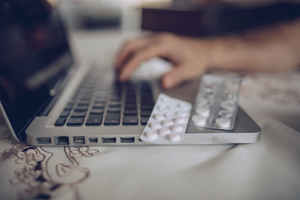 istock Patient's hand on laptop keyboard 1180590470