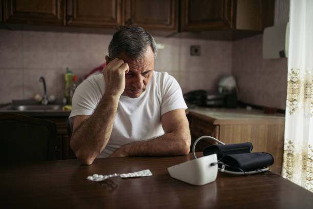 istock An elderly man measures blood pressure at home 1180591039