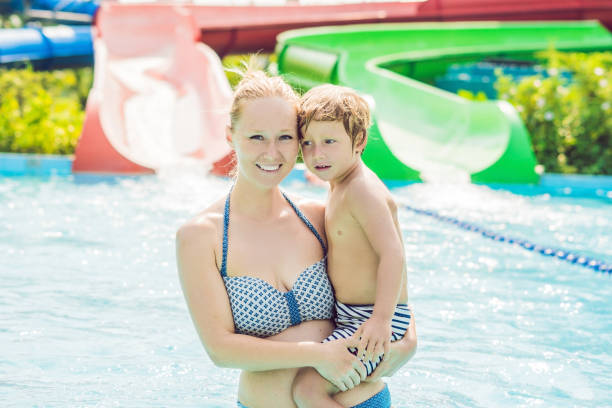 Mom and son have fun at the water park Mom and son have fun at the water park. family beach vacations travel stock pictures, royalty-free photos & images