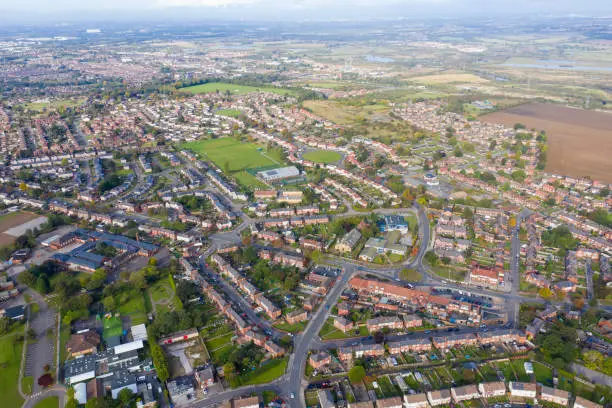 Aerial photo of the town of Castleford in the district of Wakefield in the UK, showing roof top view of typical UK rows of houses and streets.