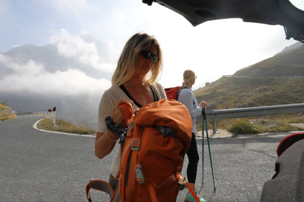 istock Mother and daughter prepare for hike from car tailgate 1180596604
