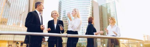 istock Happy business team members talking outside in 1180598684