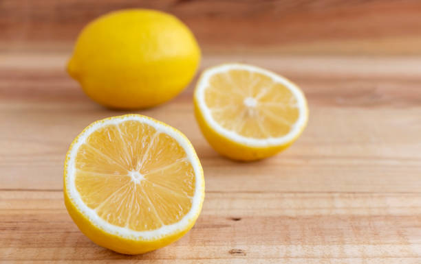 istock Fresh lemon sliced or half cut placed on wooden table. 1180598901