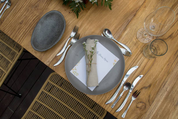 istock Restaurant concept. Wedding or festive table setting. Ceramic plate and cutlery with menu. Beautiful and simple arrangement. 1180600365