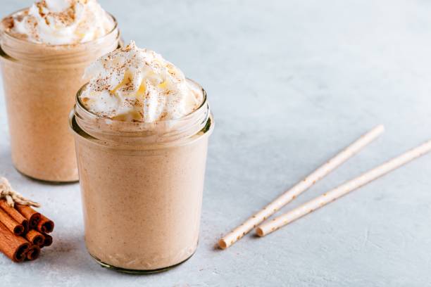 pumpkin and carrot spice latte with whipped cream and cinnamon in glass jars - latté pumpkin spice coffee imagens e fotografias de stock