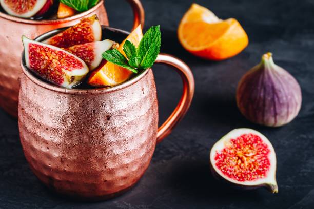 istock Fig moscow mule ice cold cocktail in copper cup with oranges and mint 1180601404