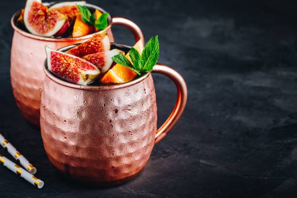 istock Fig moscow mule ice cold cocktail in copper cup with oranges and mint 1180601431