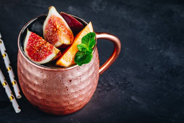 istock Fig moscow mule ice cold cocktail in copper cup with oranges and mint 1180601460