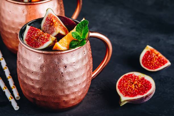 istock Fig moscow mule ice cold cocktail in copper cup with oranges and mint 1180601511