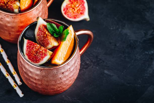 istock Fig moscow mule ice cold cocktail in copper cup with oranges and mint 1180601586