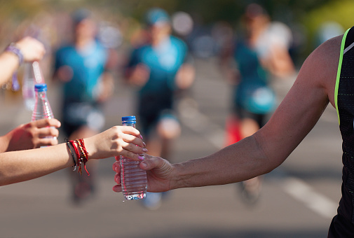 Drinks station at a running marathon, hydration drinking during a race