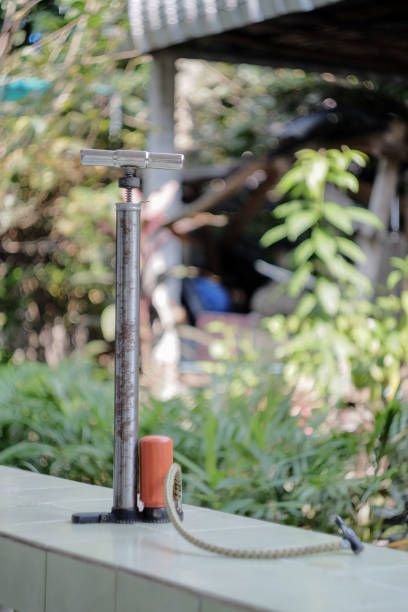 istock Vintage Air pump for bicycle on nature background. 1180603412