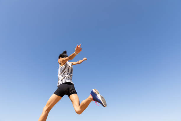course de femme d'ajustement - jumping women running vitality photos et images de collection