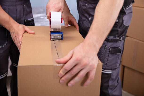 istock Young Men Packing Boxes To Move In New Flat 1180605370