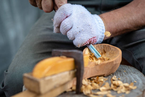 istock Craftsman demonstrates the process of making wooden spoons handmade using tools. National crafts concept. 1180605421