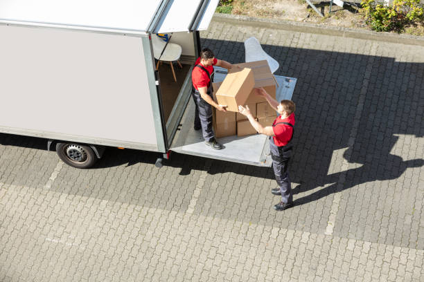 istock Male Movers Unloading The Cardboard Boxes Form Truck 1180605555