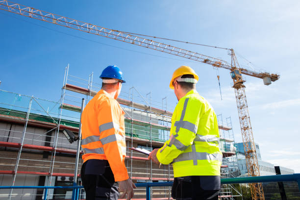 istock Two Male Engineers Supervising The Construction Site 1180607316