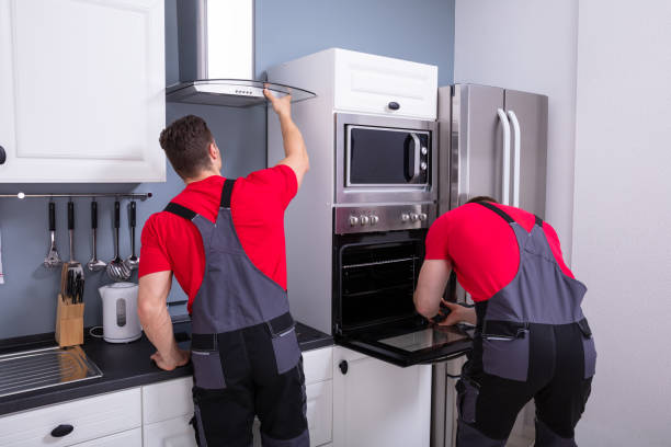 istock Two Male Technician Fixing The Home Appliances In Kitchen 1180607324