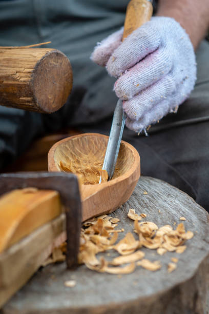 istock Craftsman demonstrates the process of making wooden spoons handmade using tools. National crafts concept. 1180607530