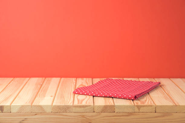 istock Christmas empty wooden table with tablecloth over red festive background 1180607562
