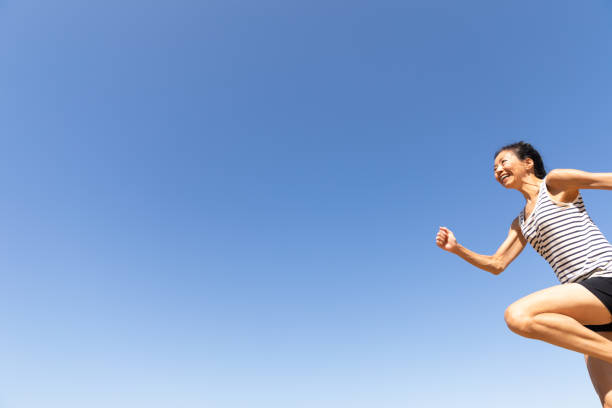 travel concept - happy girl jumping on the beach, summer holiday.