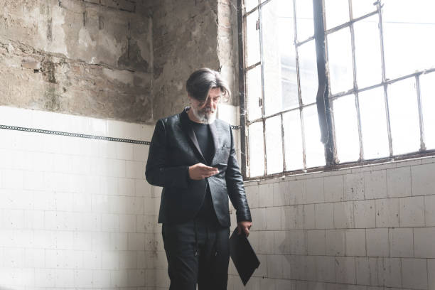 istock Mature urban professional man using smart phone. 1180610415