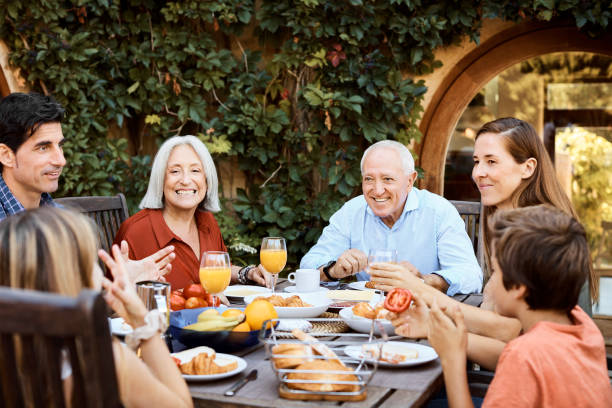 istock Multi-generation family enjoying food in backyard 1180611418