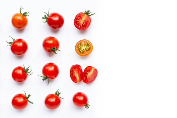 istock Fresh tomatoes, whole and half cut isolated on white background. 1180611487