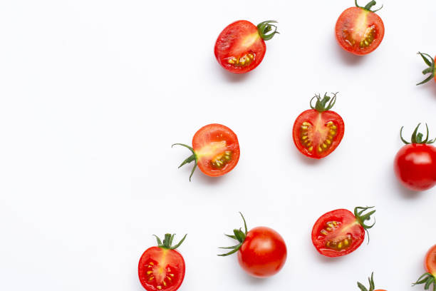 istock Fresh tomatoes, whole and half cut isolated on white background. 1180611501