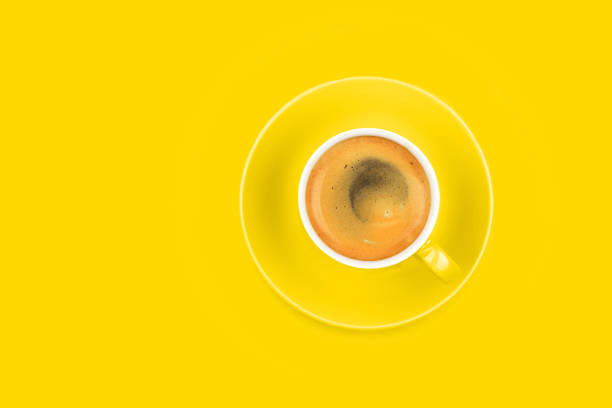 istock One full espresso coffee cup with saucer on yellow 1180611764