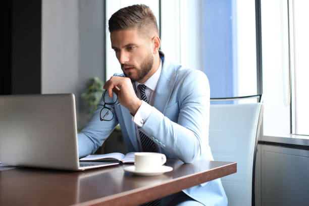 istock Modern businessman thinking about something while sitting in the office 1180613858