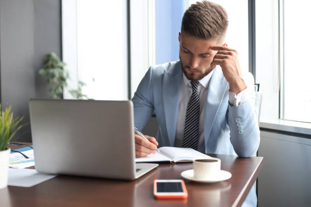 istock Modern businessman thinking about something while sitting in the office 1180613920