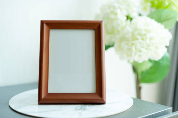 istock Blank wooden picture frame at the desk 1180614022