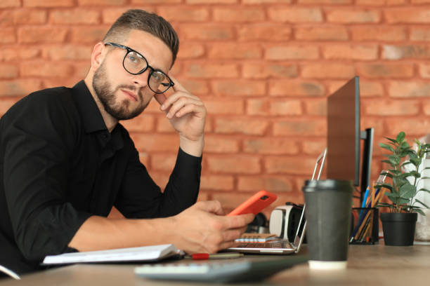 istock Businessman using his mobile phone in the office 1180615380