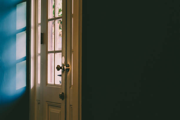 istock Light and shadow abstract.Sun shaded white wooden door frame and panel 1180616446
